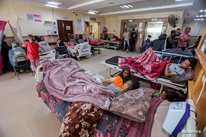 Palestinians wounded in Israeli fire lie on beds as they receive treatment at Al-Aqsa hospital in Deir Al-Balah in the central Gaza Strip